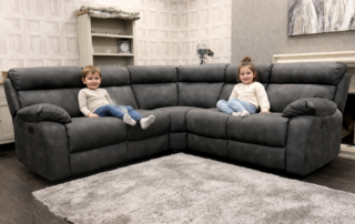 Kids playing near a sturdy leather sofa