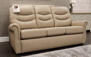 Durable commercial leather 3-seater sofa set up in a modern holiday let living room.