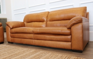Tan leather 3-seater sofa, a hard-wearing, easy-clean upholstery choice for holiday let and Airbnb furnishing.